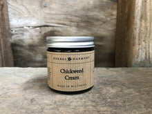 Load image into Gallery viewer, A clear glass jar with an aluminum lid containing Chickweed cream, with a label that includes the brand name 'Herbal Harmony' and the product name 'Chickweed Cream'.
Handmade cream made with Chickweed infusion, chickweed infused oil, rosewater, aloe vera, cocoa butter and lavender essential oil.